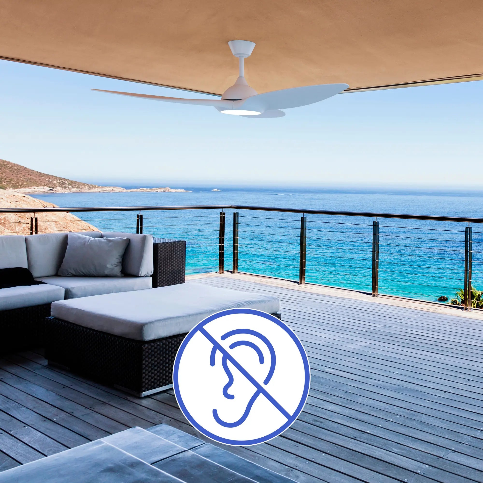 Slique Ceiling Fan installed on a shaded coastal deck with lounge seating, emphasizing whisper-quiet performance and year-round airflow; a blue ear-with-slash icon represents silent operation.