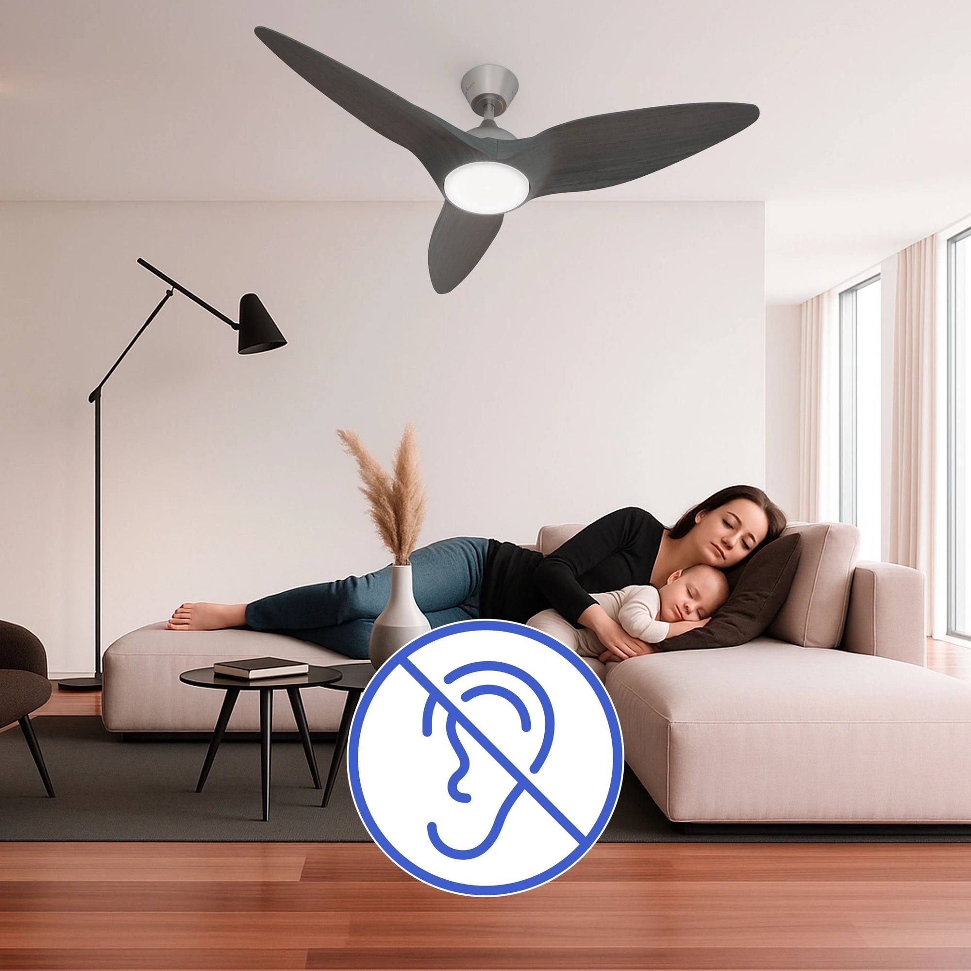 A serene living room shows a woman and a baby peacefully sleeping on a sofa under the Monarc Smart Ceiling Fan. A blue ear-with-slash icon represents silent operation.